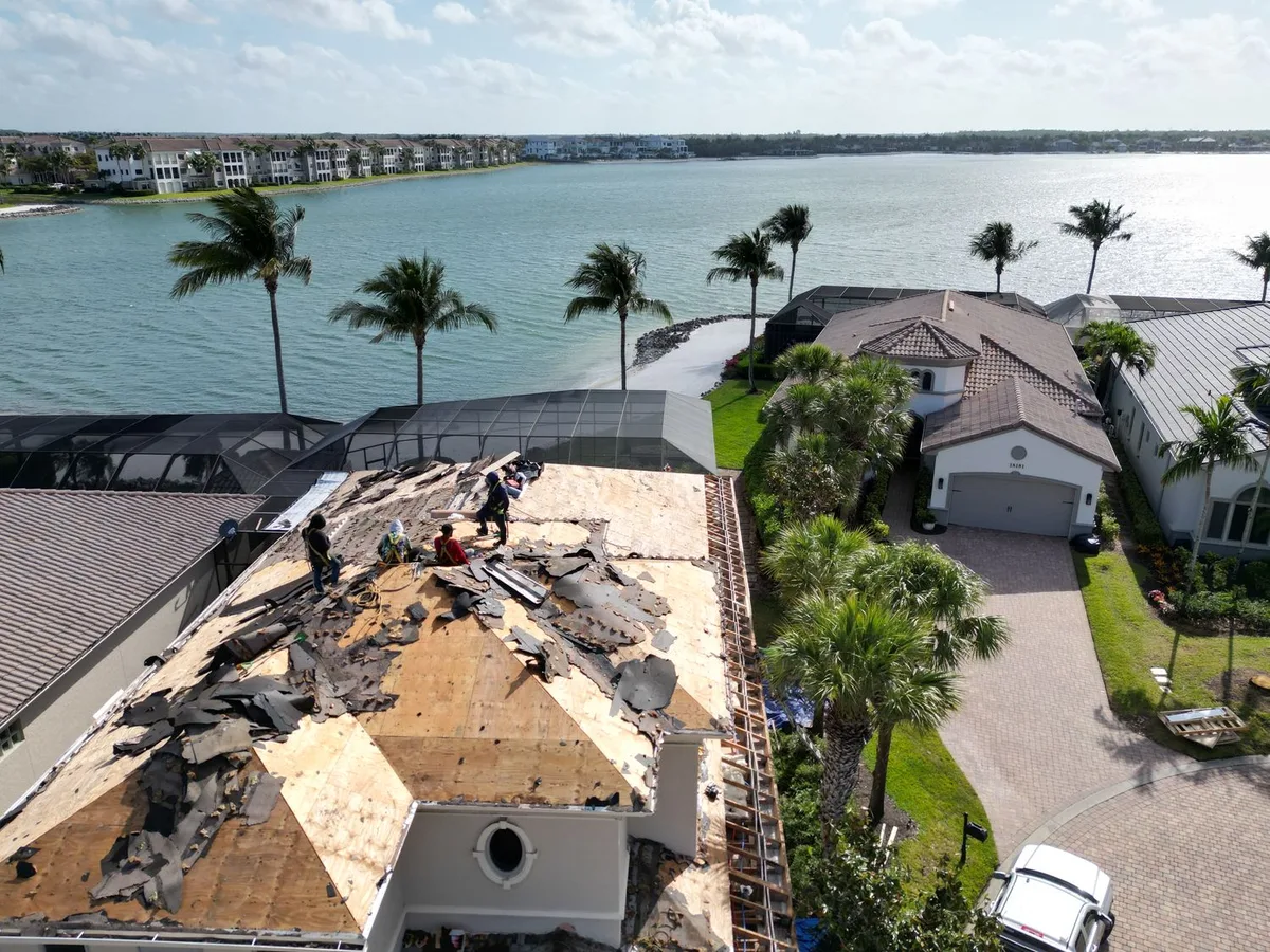 Miromar Lakes waterfront home — tear-off day, water behind