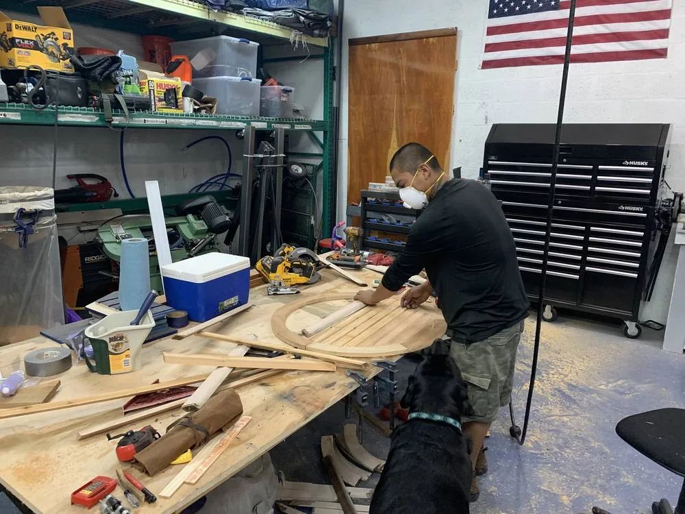 Hand-building a custom gable vent in the Blue Dog shop — Scout supervising