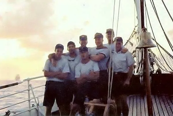 Crew on deck of the Eagle at sunset
