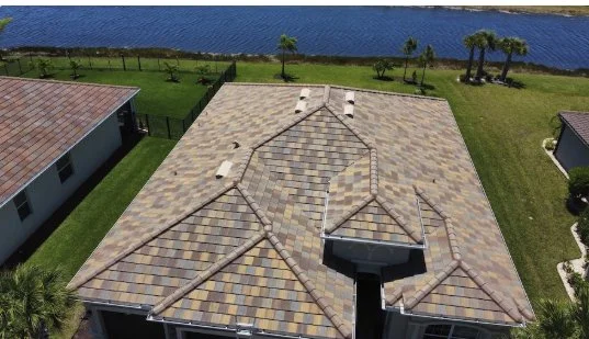 Multi-color tile roof on a waterfront home — aerial