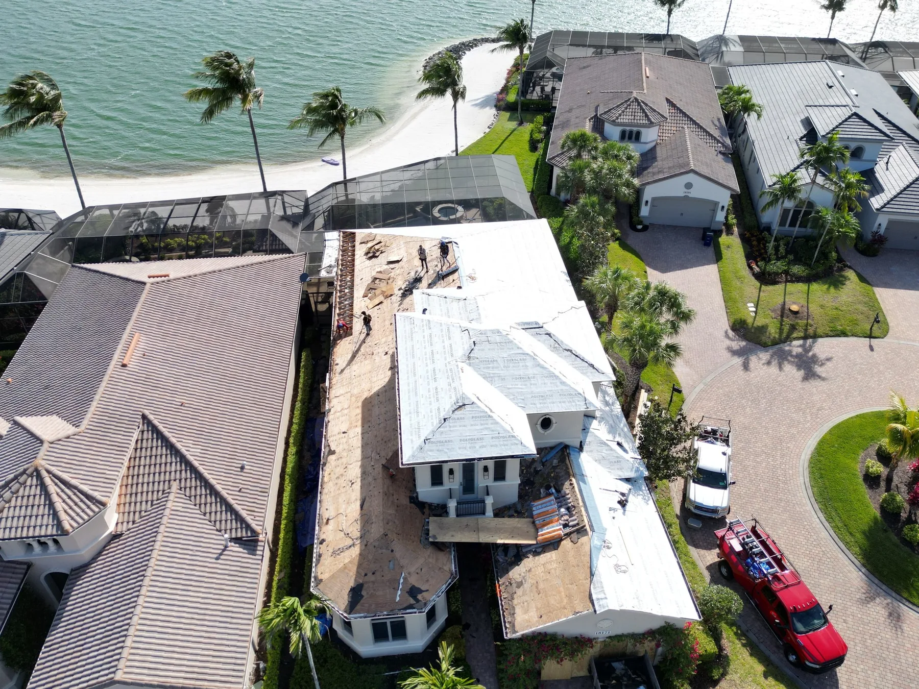 Blue Dog crew drying in a waterfront home in Southwest Florida — roof opened, underlayment going down the same day