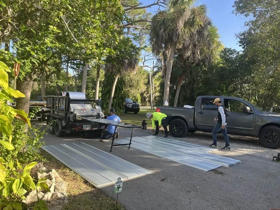 Blue Dog crew forming standing-seam metal panels on site in Punta Gorda