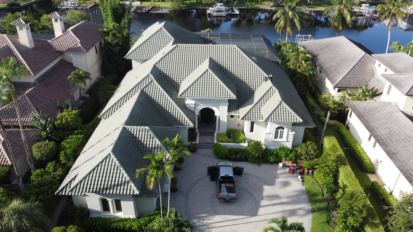Canal-front Fort Myers estate with a new flat tile roof and paver courtyard