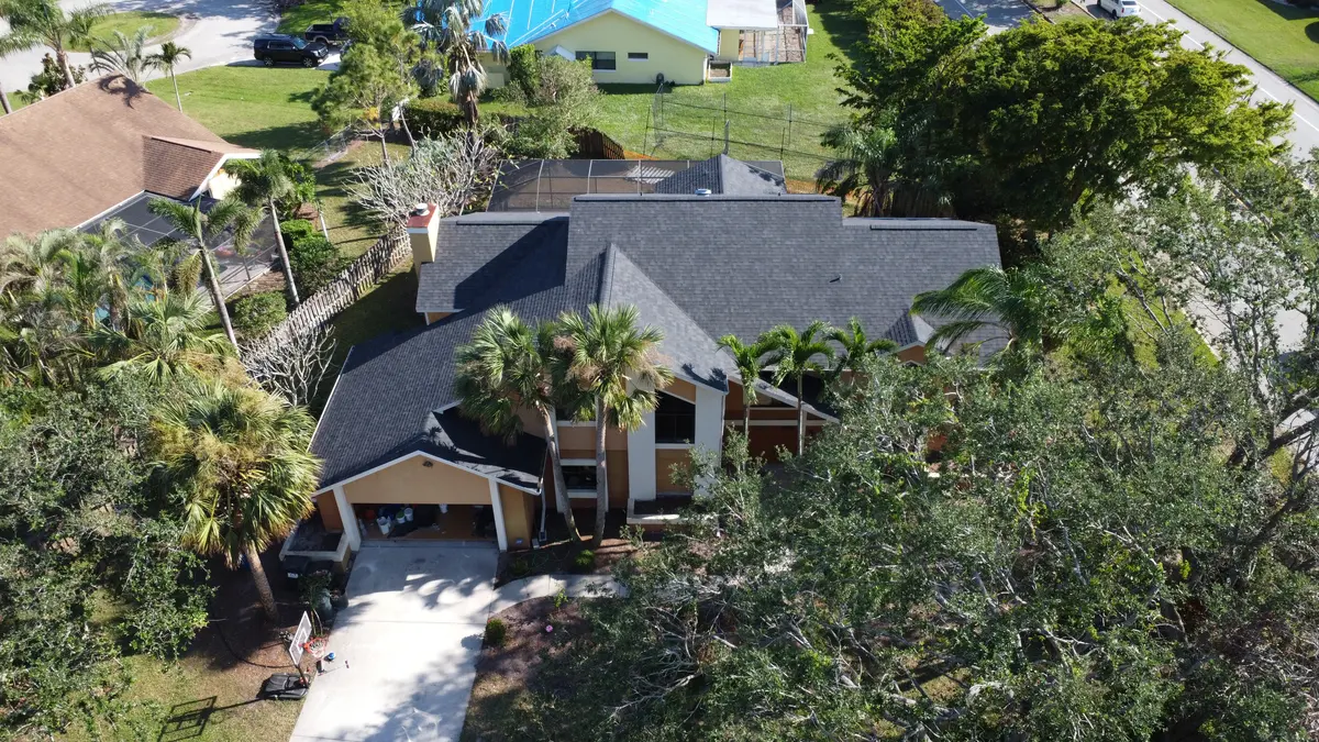 Two-story Fort Myers home with a new charcoal architectural shingle roof