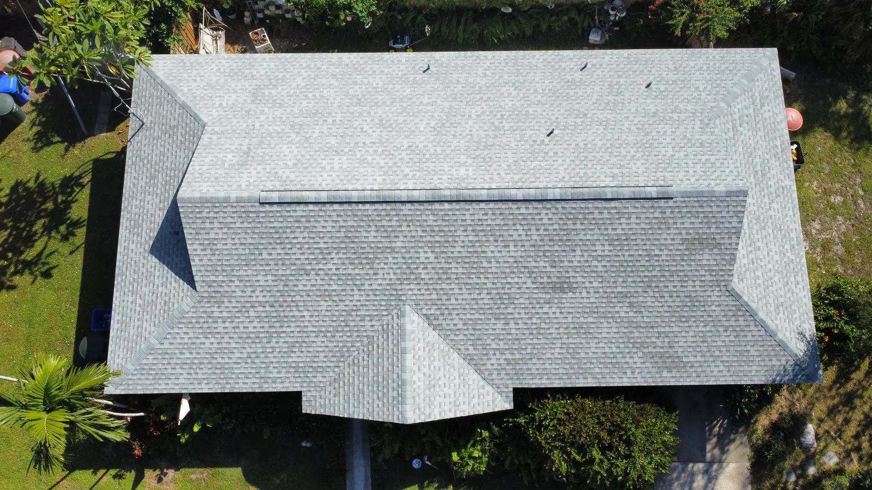 Top-down view of a new gray architectural shingle roof on a Sanibel home