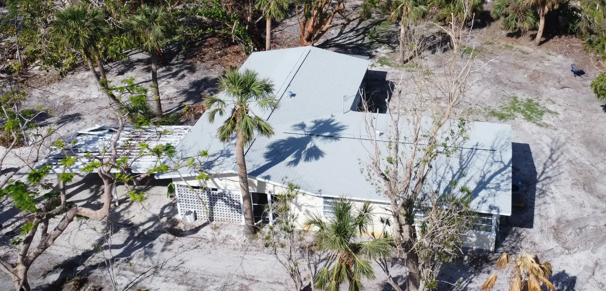 Sanibel home with a new roof after Hurricane Ian, the Gulf behind it