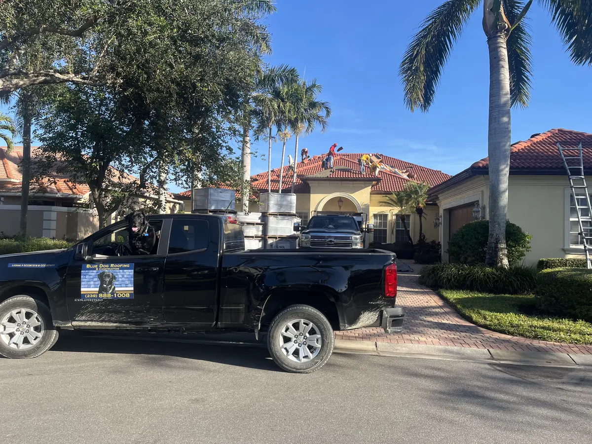 Blue Dog truck and crew loading tile at a Punta Gorda home