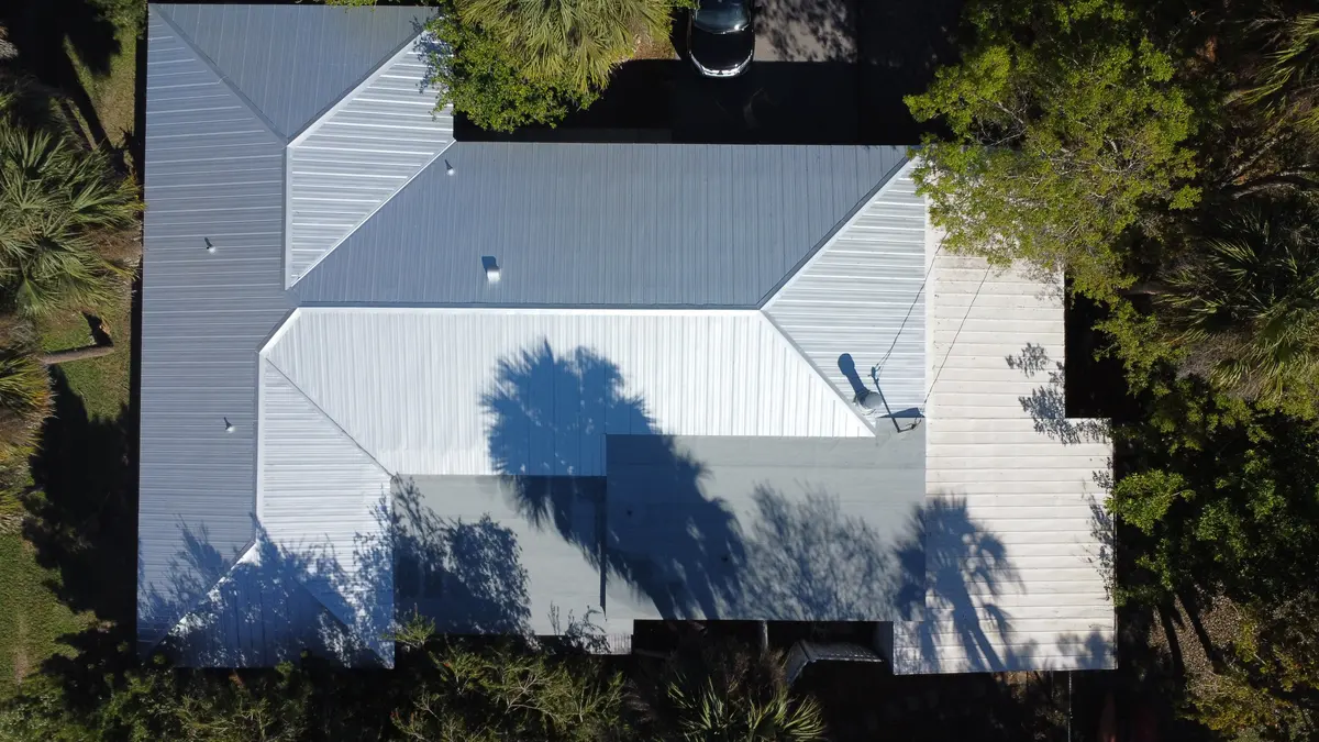 Top-down view of a finished white standing-seam metal roof in Punta Gorda