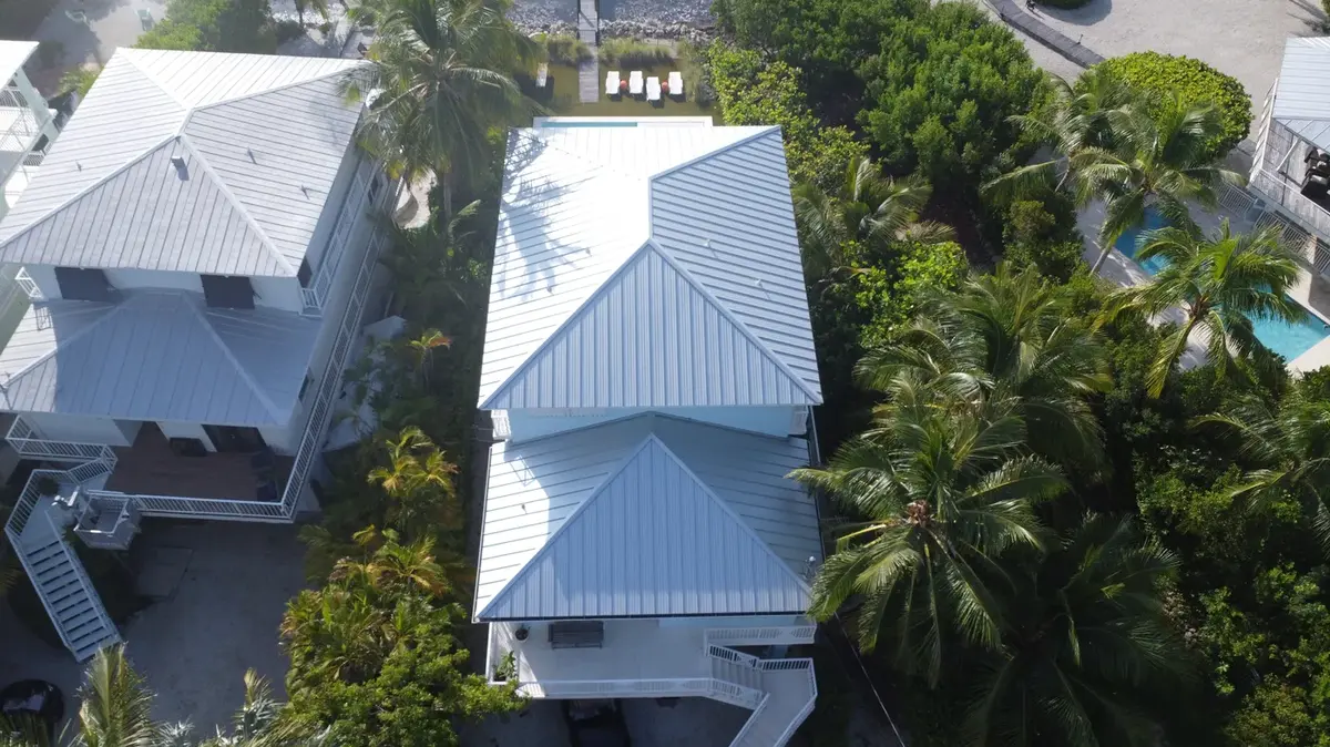 Two-story Bonita Springs home with a new white metal roof