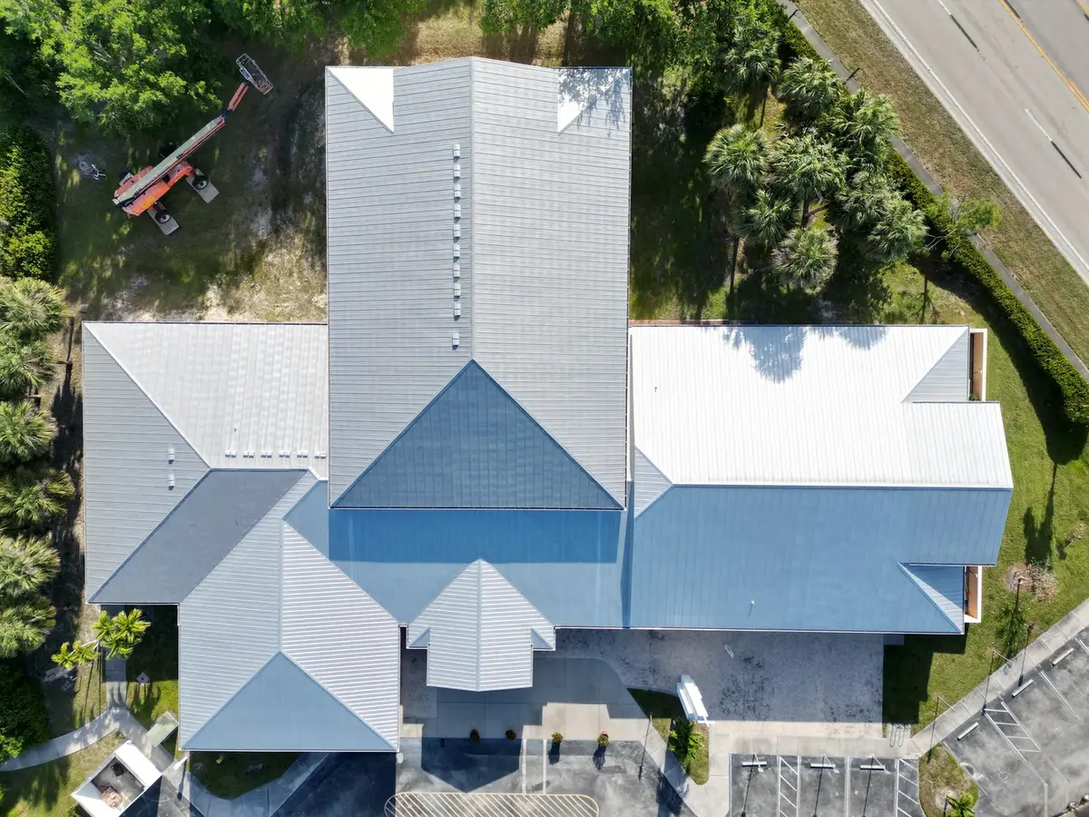 Light standing-seam metal roof on a large Bonita Springs home