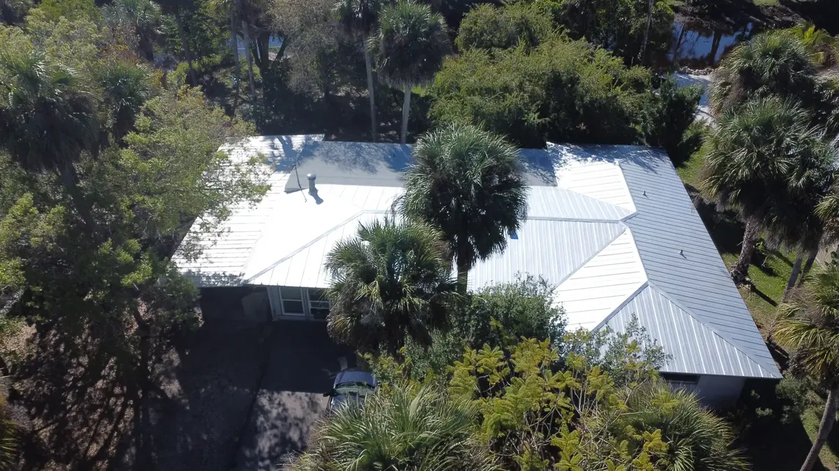 White standing-seam metal roof on a Southwest Florida home
